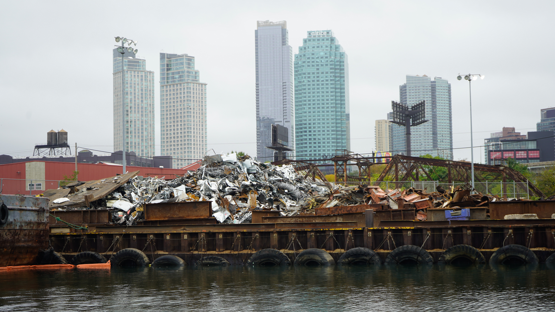 City skyline behind a scrap barge